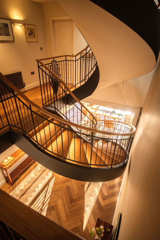 Curved Staircase with Metal Spindle Balustrade with Handcrafted Details - Design Fabrications