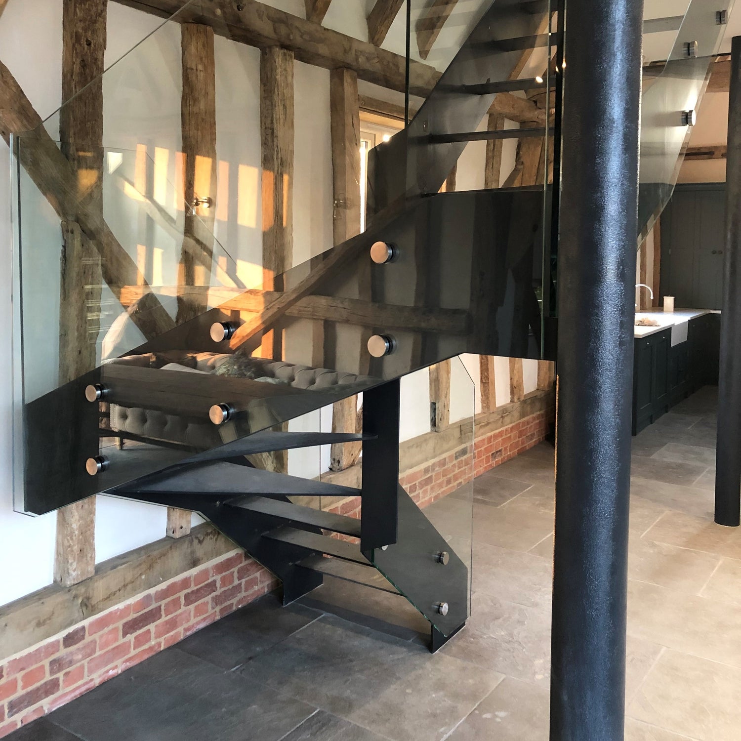 single stringer staircase, with 15mm structural glass as a frameless balustrade, secured with stainless steel fixings. This project also included custom made squared European Oak handrail.
Project Location: Saffron Walden, Essex
Barn Conversion