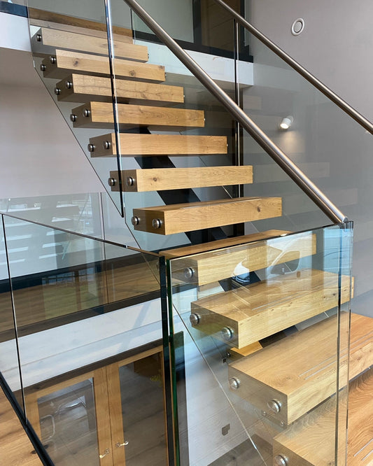 Central Spine Staircase with Wrap-Around Treads and Frameless Glass Balustrade - Great Dunmow, Essex - Design Fabrications
